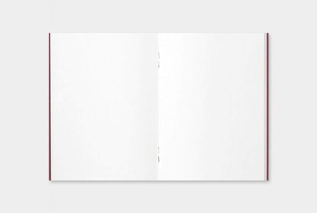 an open, blank notebook with a red spine.