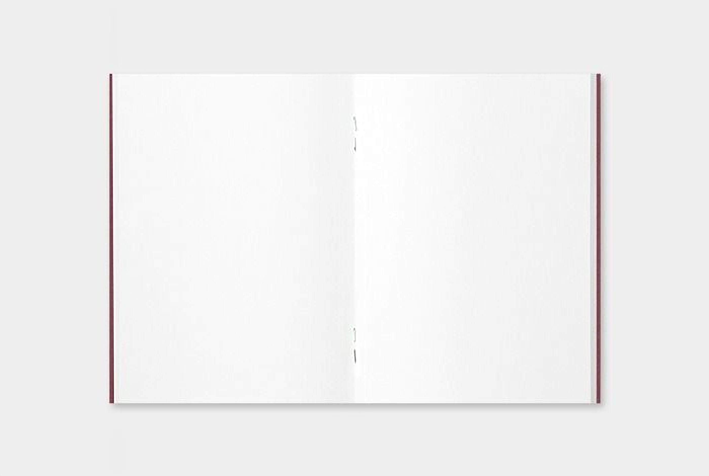 an open, blank notebook with a red spine.