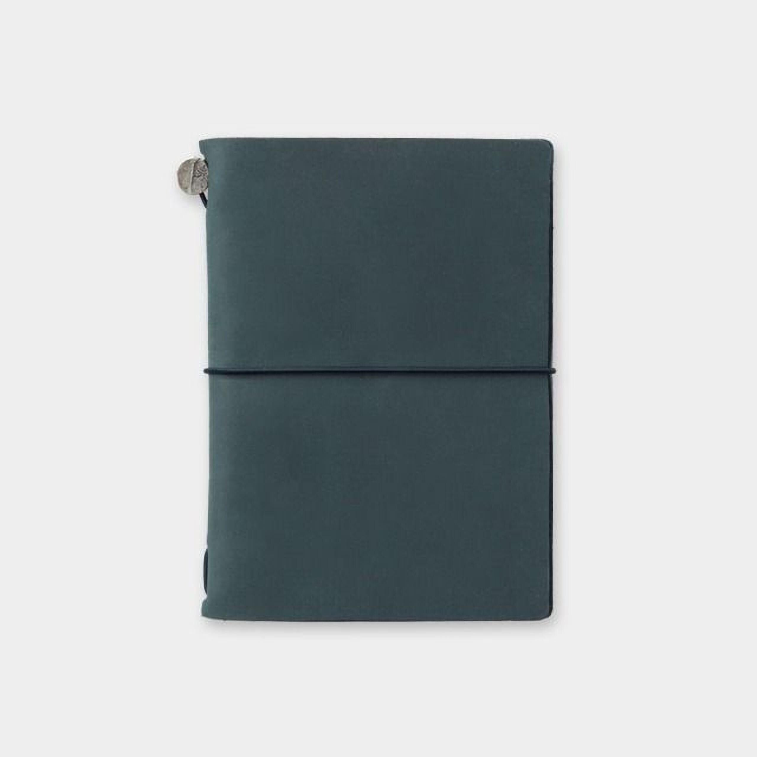 a dark green, rectangular-shaped notebook or journal with a black band around the top edge.
