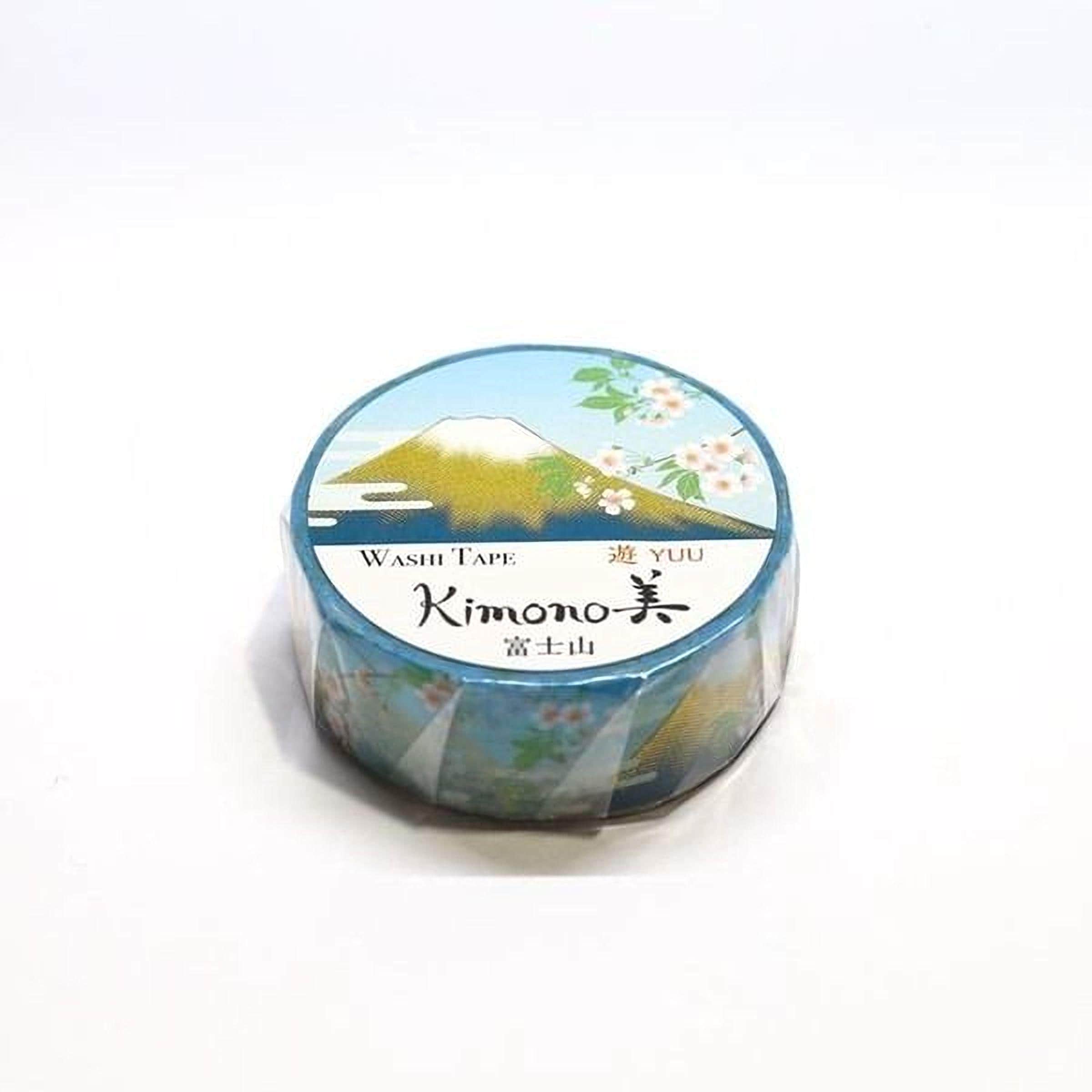 A roll of washi tape with a floral design and a mountain landscape printed on it.