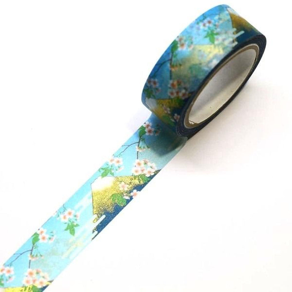 A roll of blue and gold floral patterned tape is lying on a white surface.