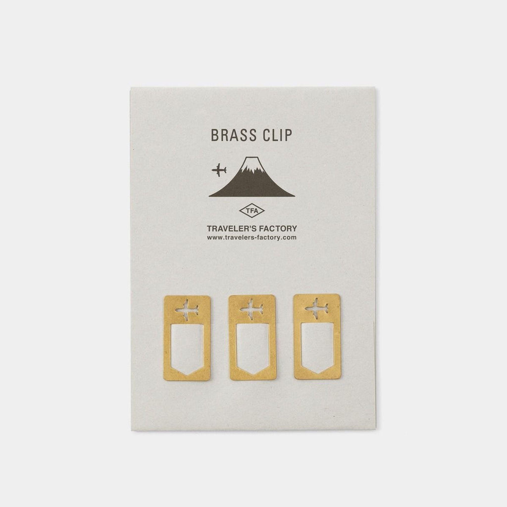 three brass clip holders, each with a unique design, placed on a white background.