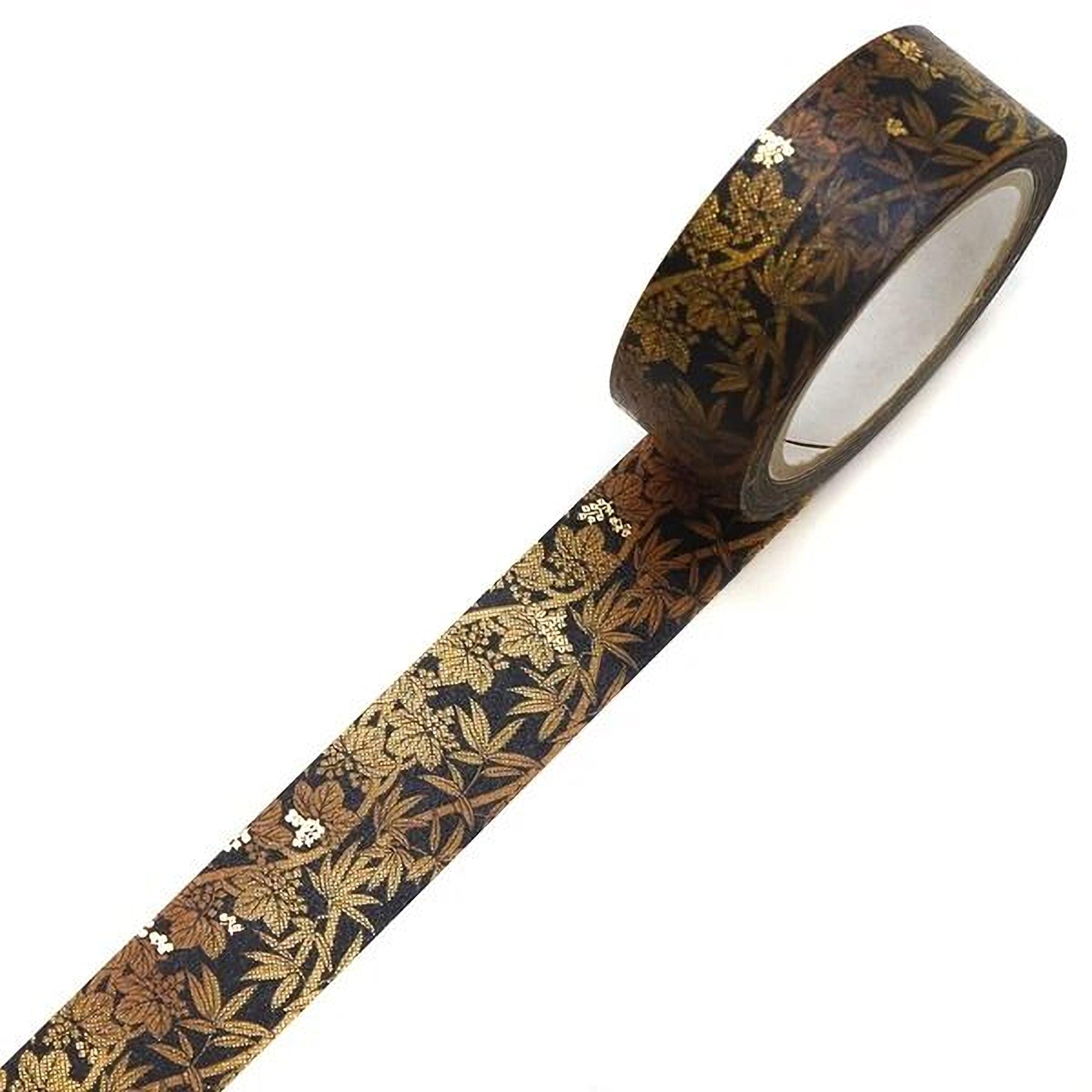 A roll of black and gold patterned tape with a leaf design on it.