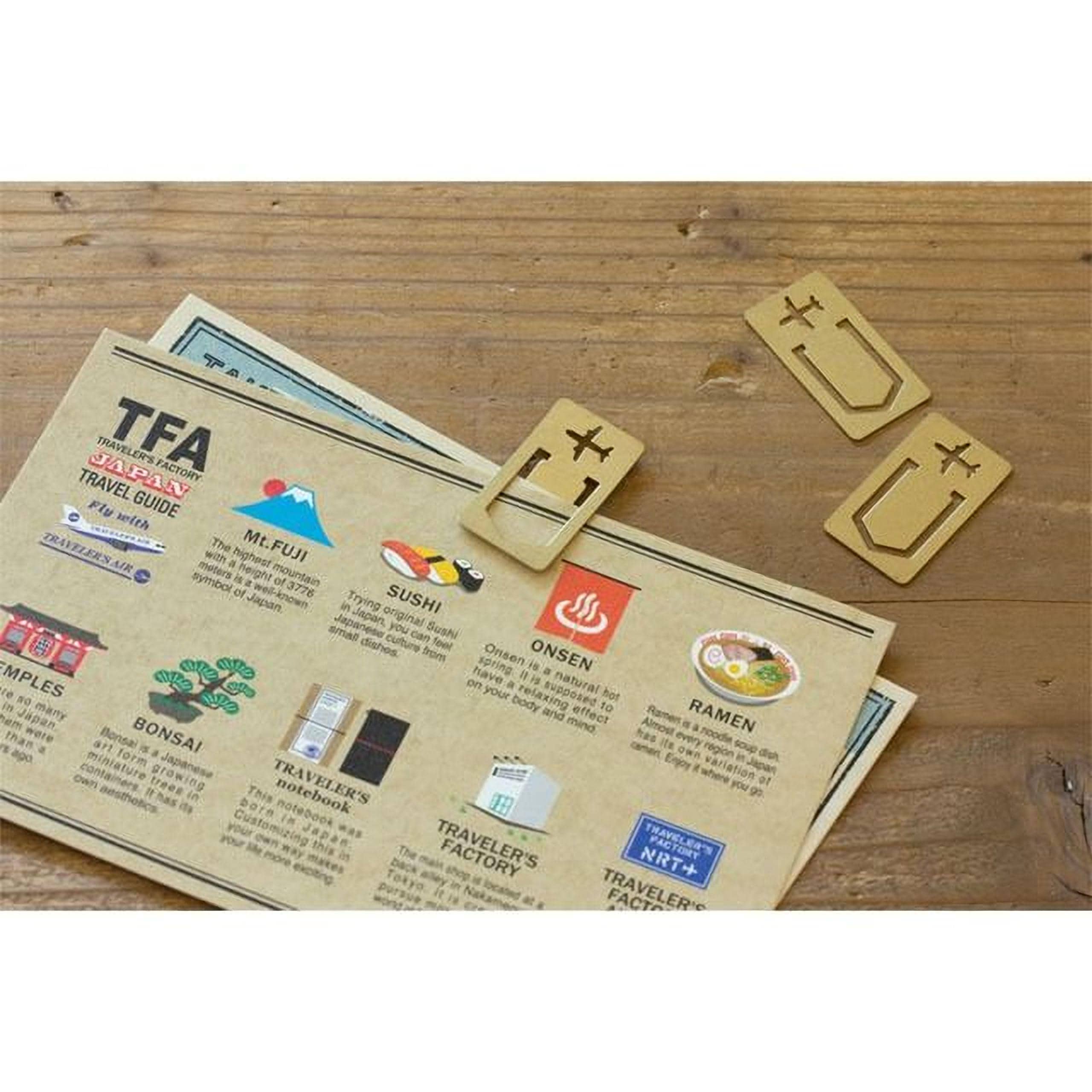 a travel guide with various destinations and attractions listed, along with a pair of golden bookmarks shaped like a cross and a star.