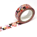 A roll of floral patterned tape is lying on a white surface.
