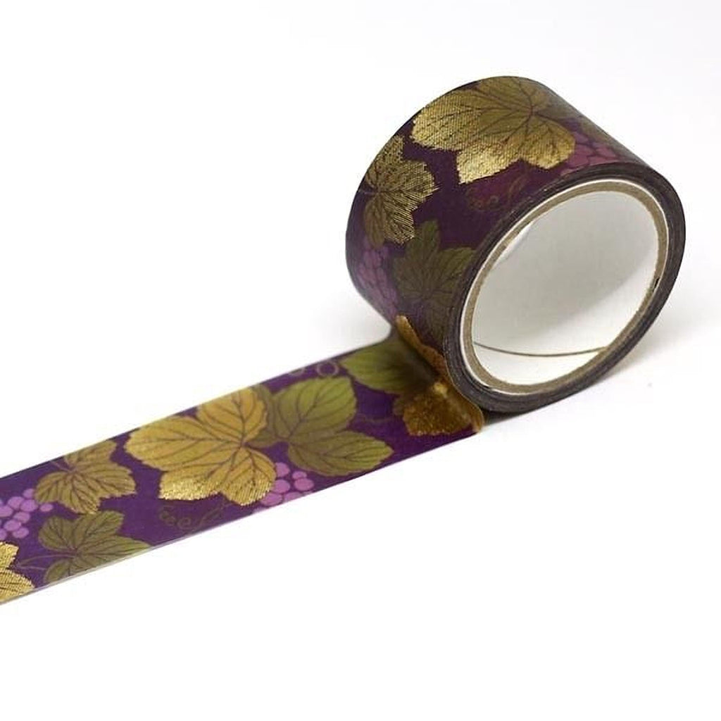 A roll of purple and gold patterned tape with a leaf design on it.