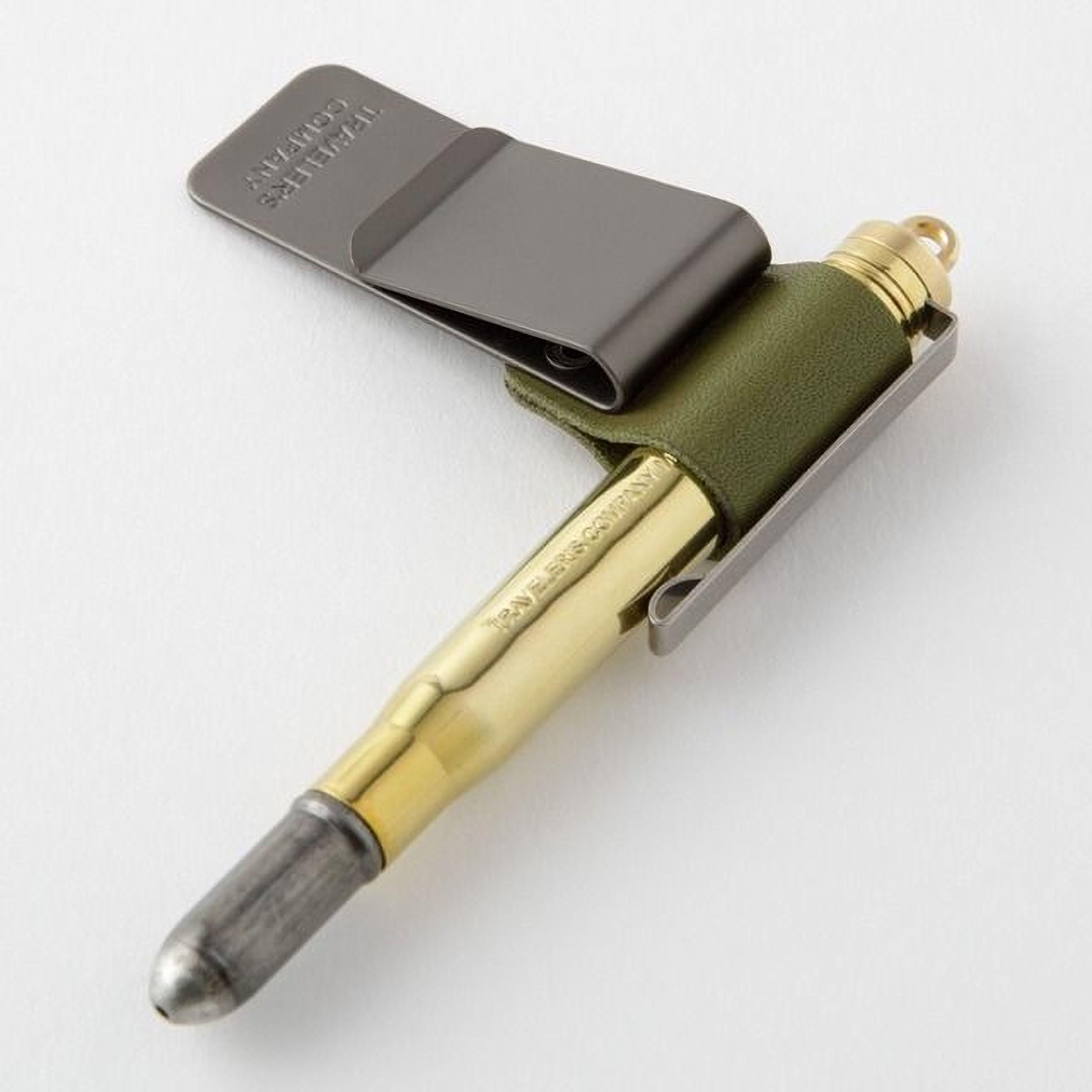 A bullet-shaped pen with a bullet casing attached to it, which appears to be a pen designed for use in a bulletproof case.
