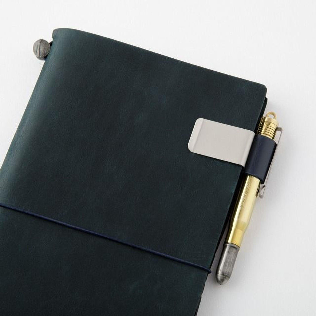 A dark green leather-bound notebook with a pen clip attached to the top right corner.