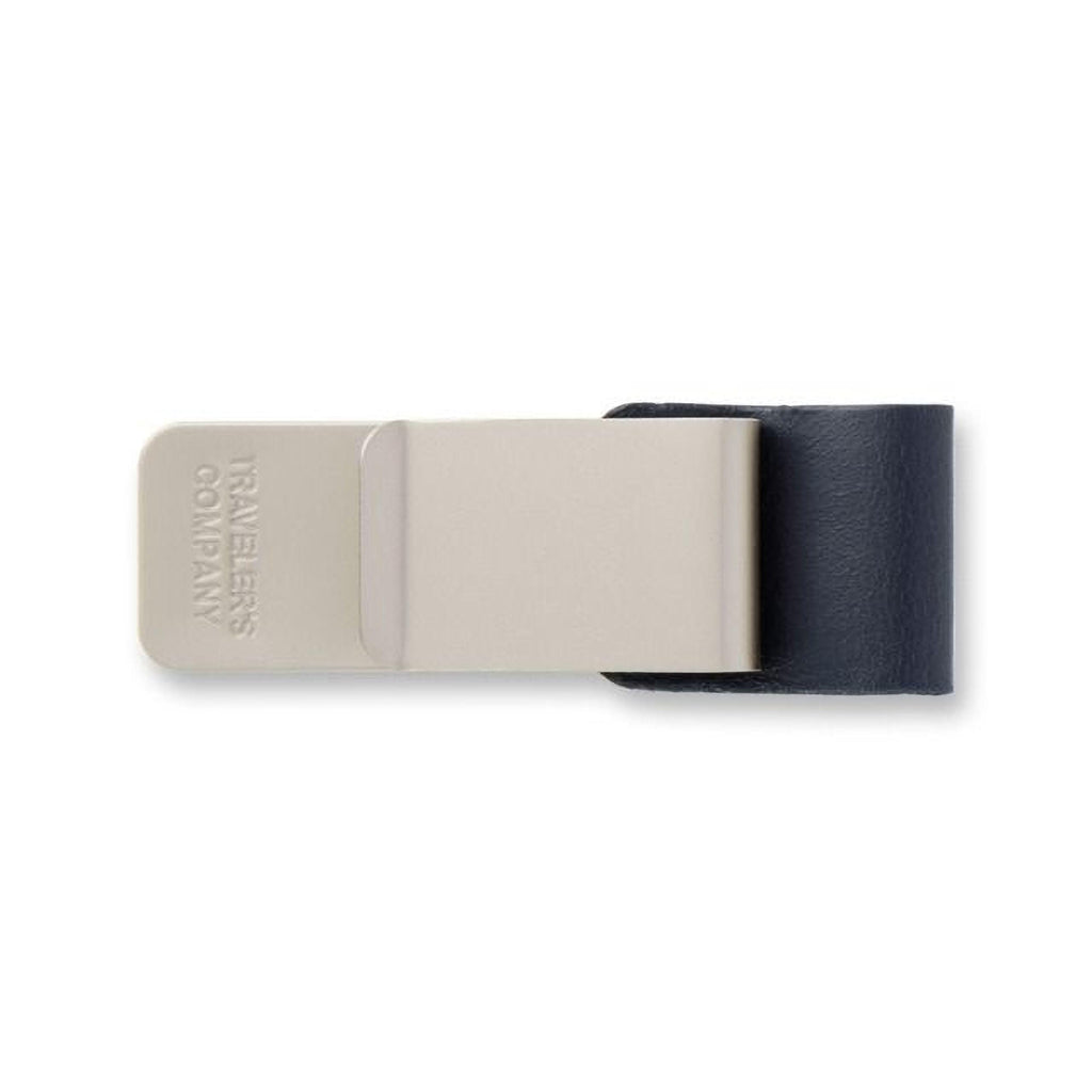 A beige and black money clip with the text "TAVES" printed on it.