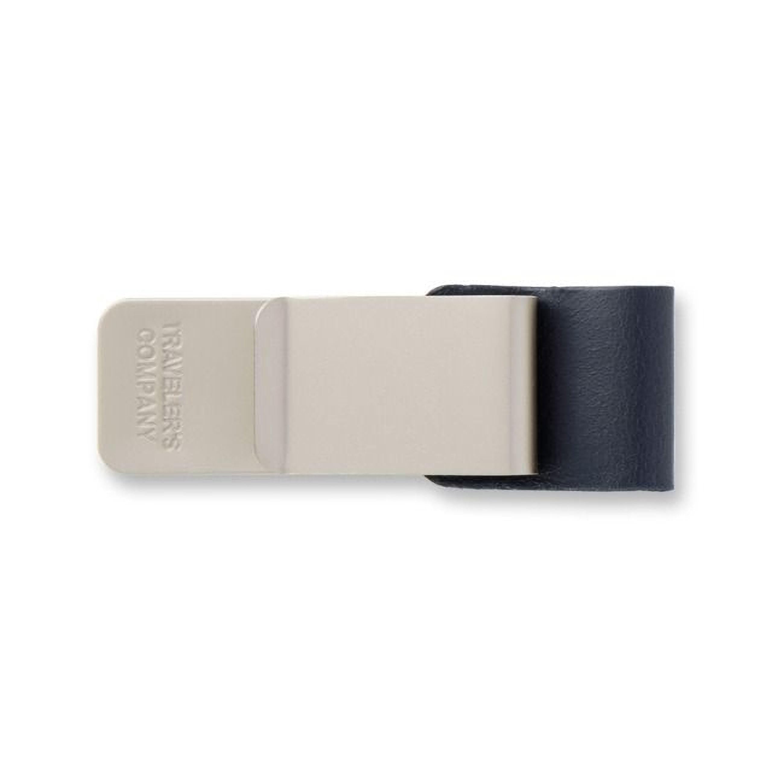A beige and black money clip with the text "TAVES" printed on it.