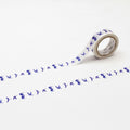 a roll of blue and white tape with a repeating pattern of blue birds on it, lying on a white surface.