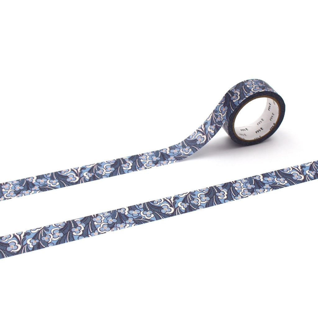 a roll of patterned tape with a blue and white floral design, lying on a white surface.