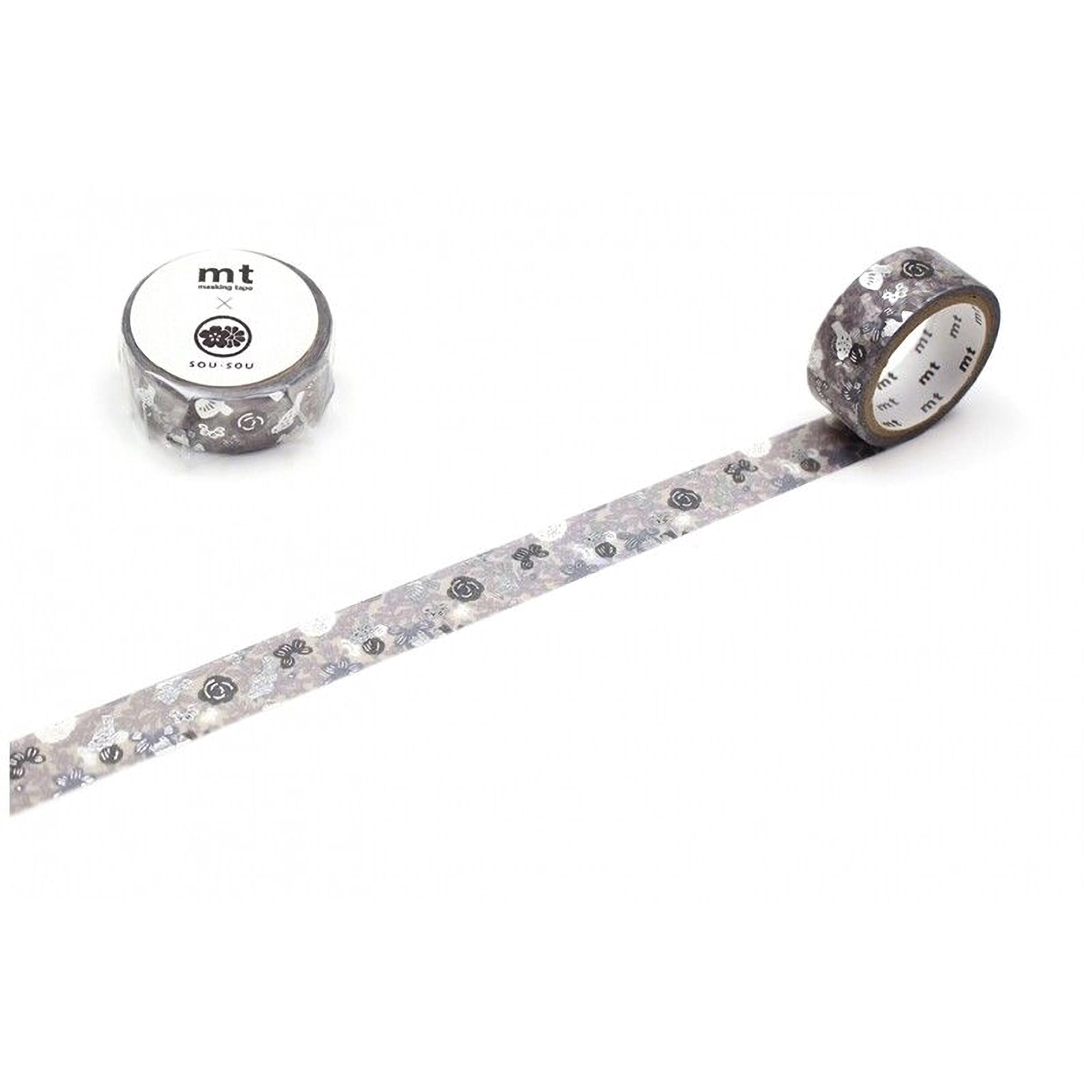 a roll of gray and white patterned tape with a floral design, lying on a white surface.