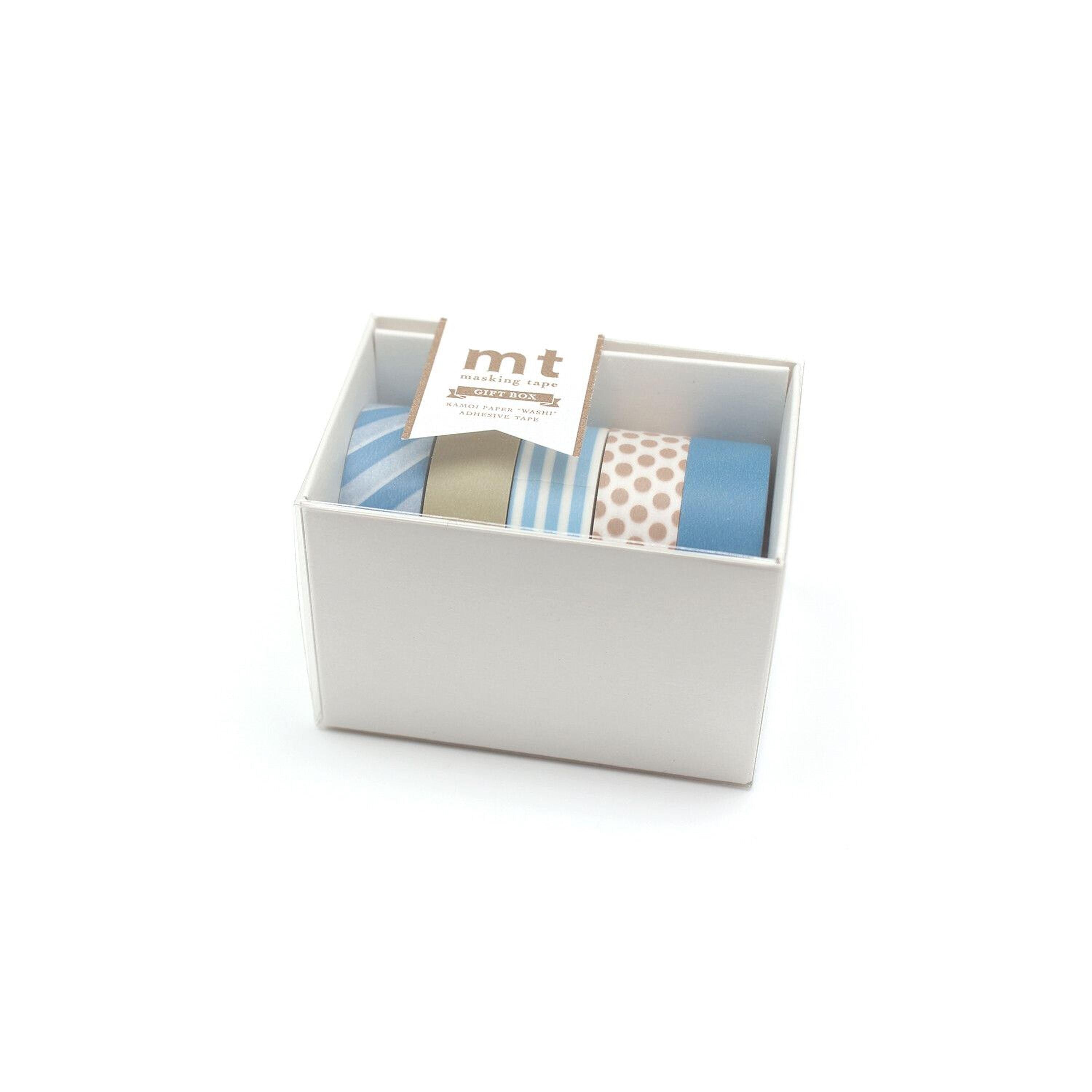 A white box containing four rolls of colorful tape, with a label indicating the contents of the box.