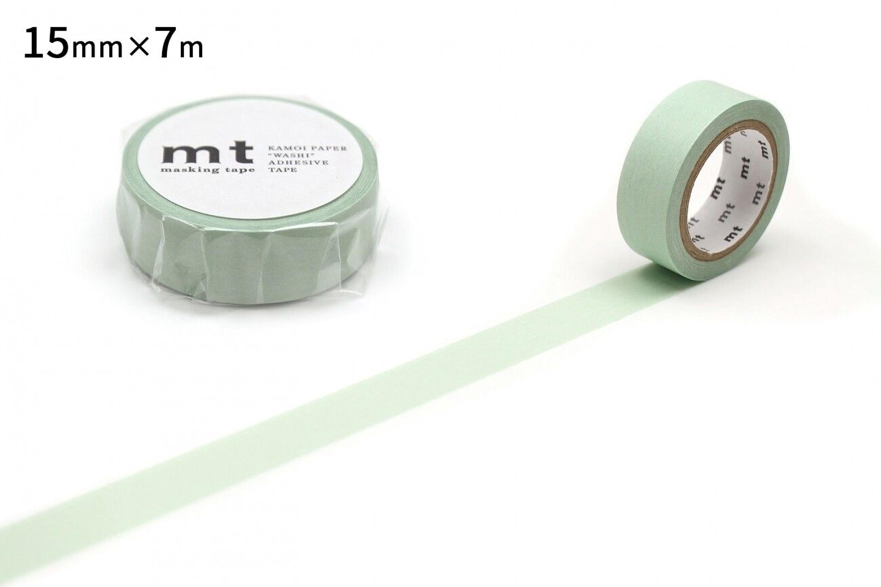 a roll of green masking tape and a single roll of the same tape, both lying on a white background.