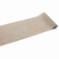 A roll of beige grid-patterned paper is shown against a white background.