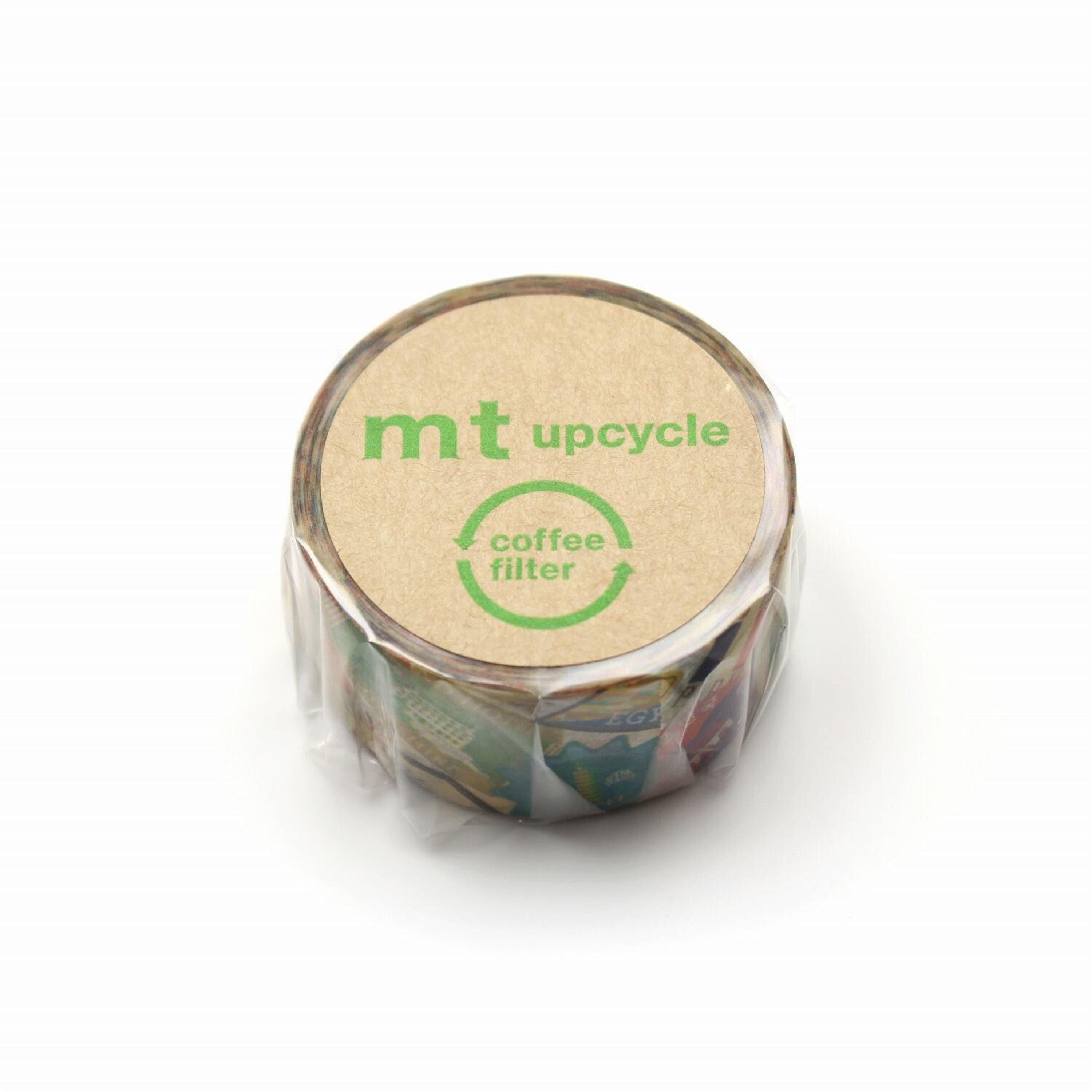 A circular object with a label that says "mt upcycle coffee filter" and features a green recycling symbol.