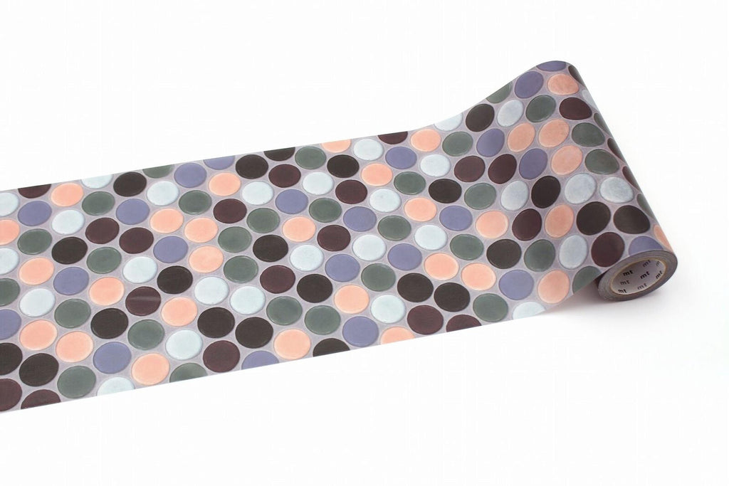 A roll of patterned tape with a repeating design of multicolored circles on a white background.