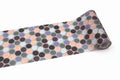 A roll of patterned tape with a repeating design of multicolored circles on a white background.