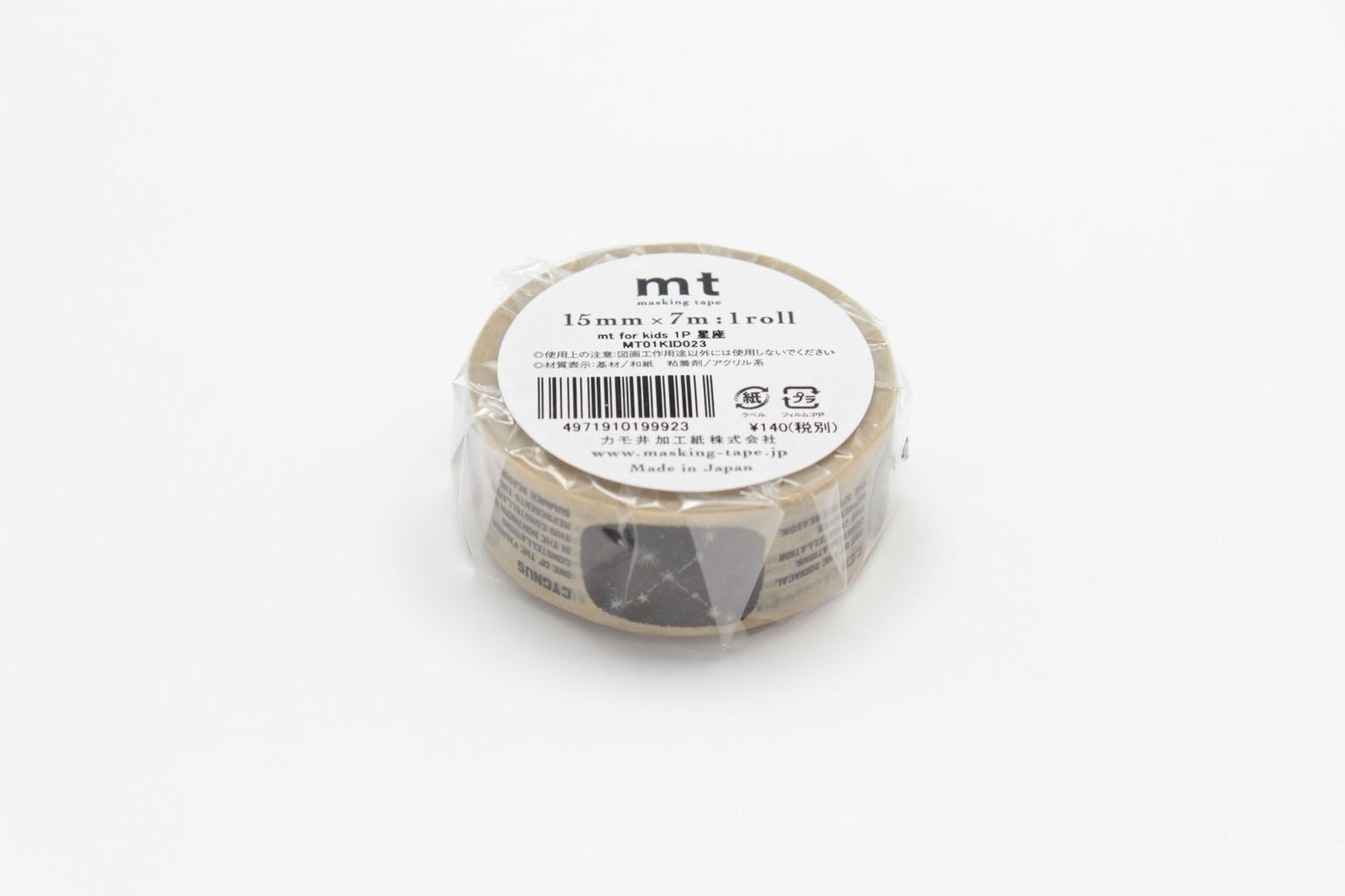 A roll of masking tape with a label on it, sitting on a white surface.