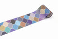 A roll of colorful patterned tape with a repeating design of various shades of blue, purple, and orange shapes.