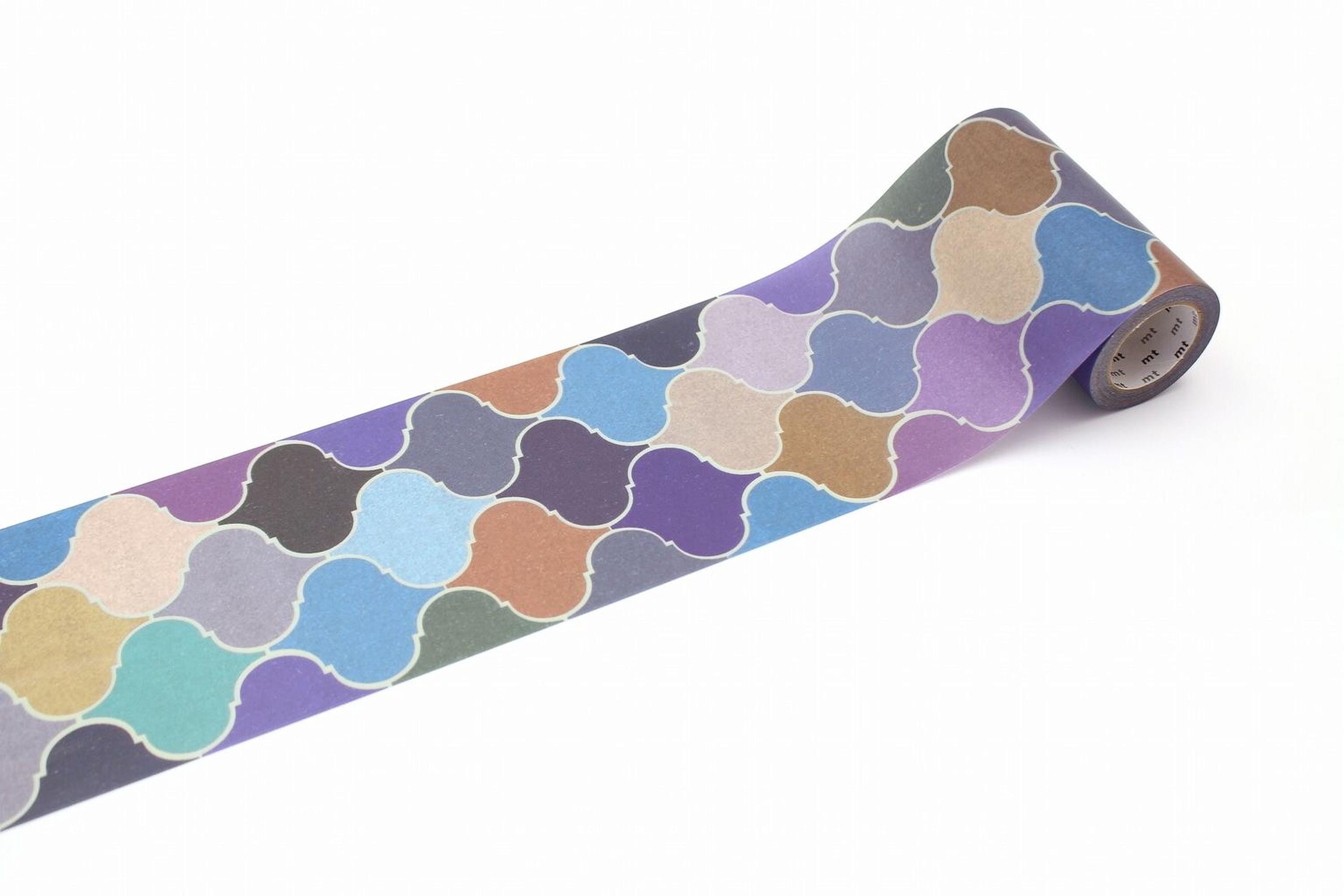 A roll of colorful patterned tape with a repeating design of various shades of blue, purple, and orange shapes.