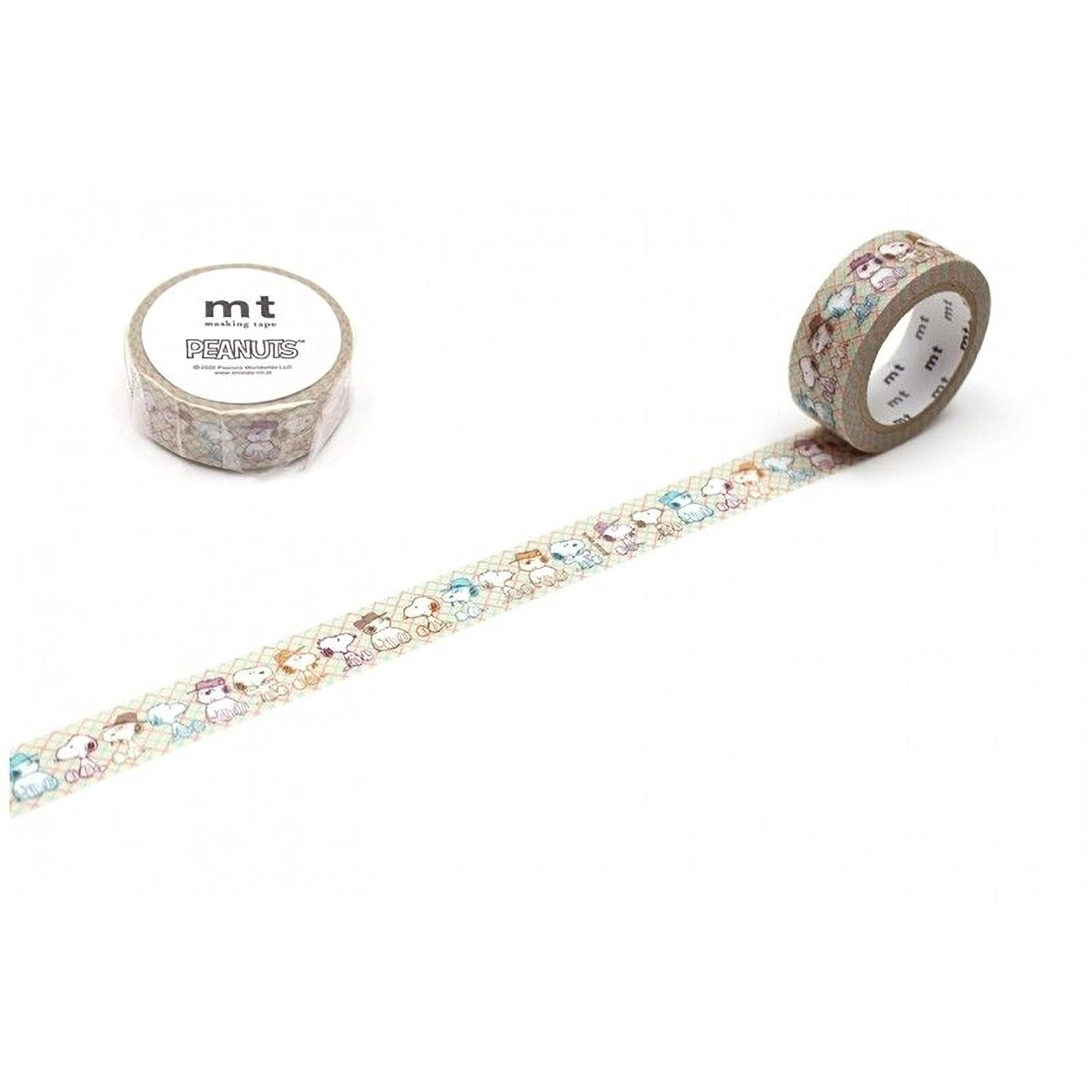 a roll of Peanuts-themed washi tape and a roll of regular washi tape, both with a pattern of cartoon characters on them.