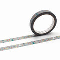 A roll of patterned tape with a Christmas-themed design is shown against a white background.