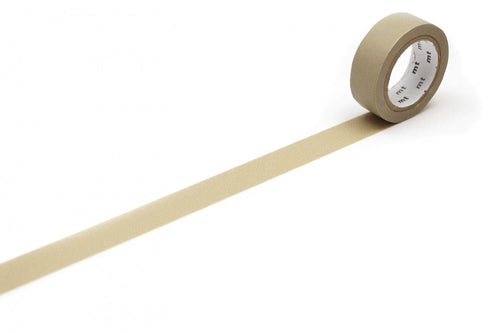 A roll of beige tape with a white label is lying on a white surface, with the tape partially unrolling and extending across the image.