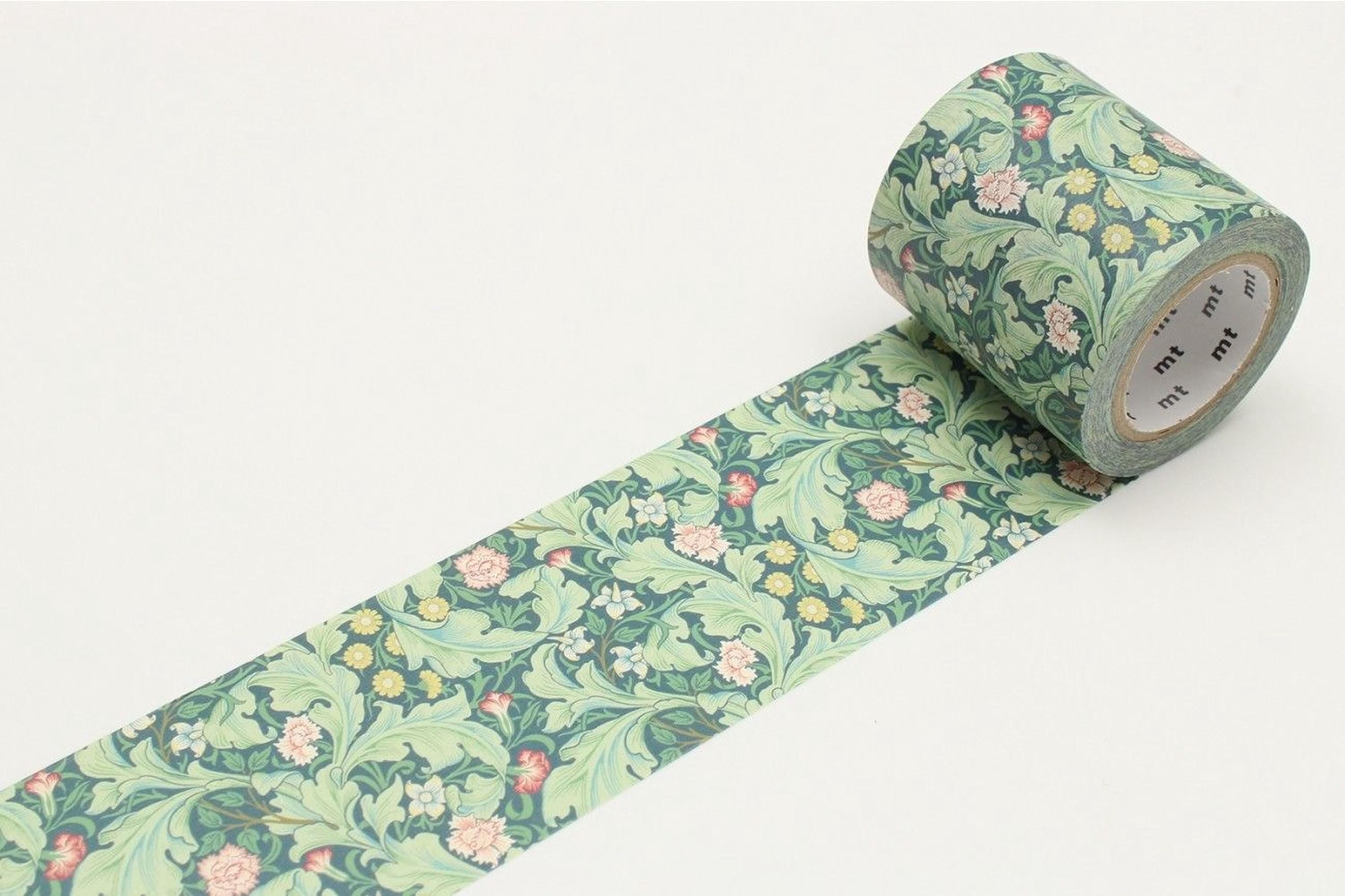 A roll of patterned tape with a floral design on it, lying on a white surface.