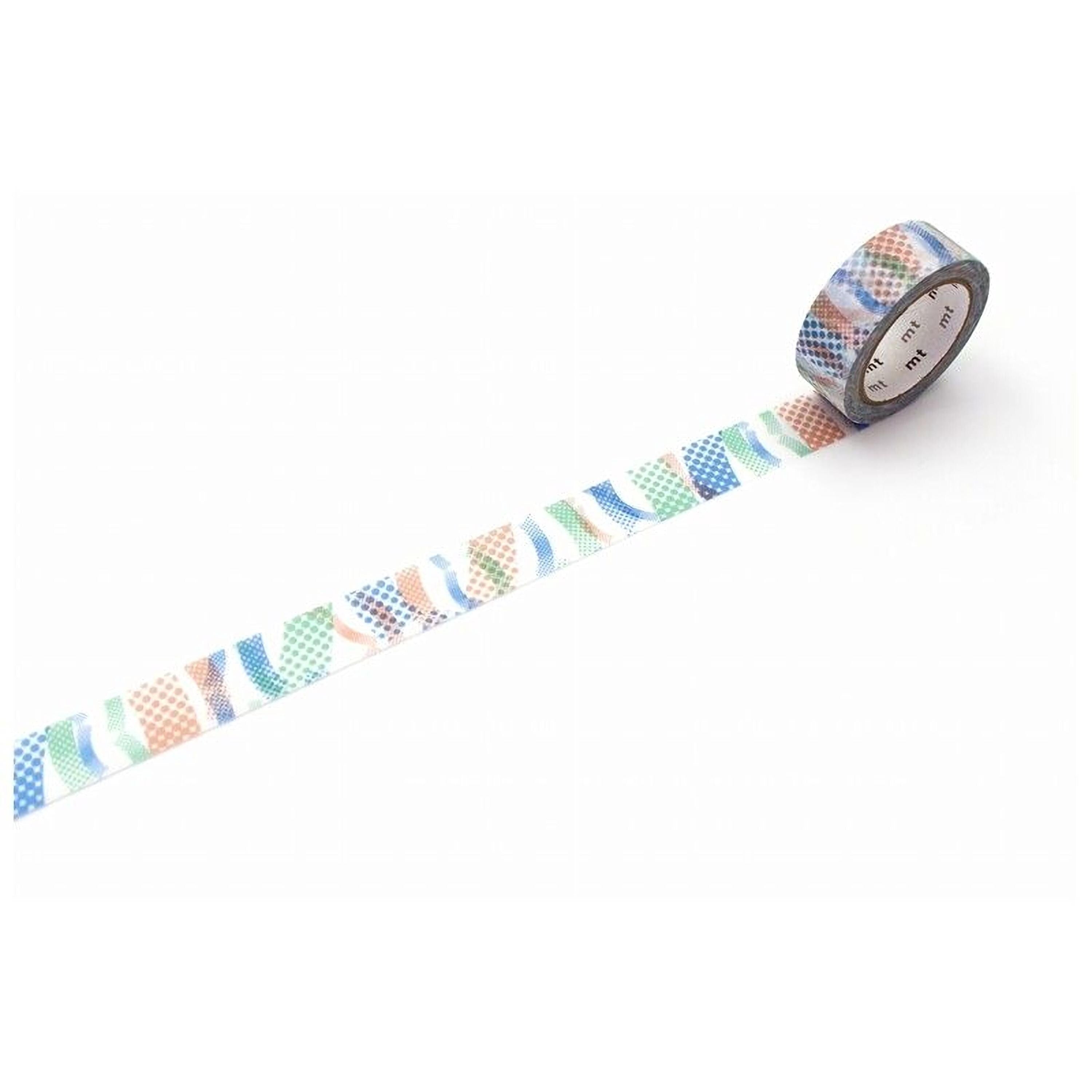 A roll of patterned tape is lying on a white surface, with a colorful design on the tape.