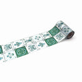 A roll of decorative paper with a repeating pattern of green and white tiles, featuring various floral and geometric designs.