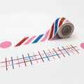 a roll of colorful tape with a pattern of red, white, and blue stripes, and a grid of pink and blue squares with the text "IOW YOU ONE" written on them.