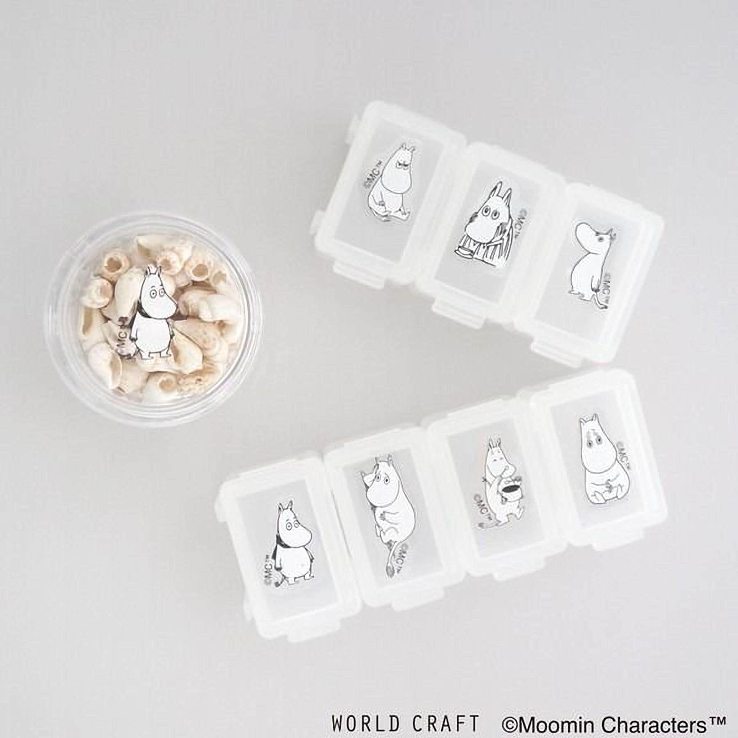 a collection of small containers with illustrations of Moomin characters, along with a small bowl containing seashells.