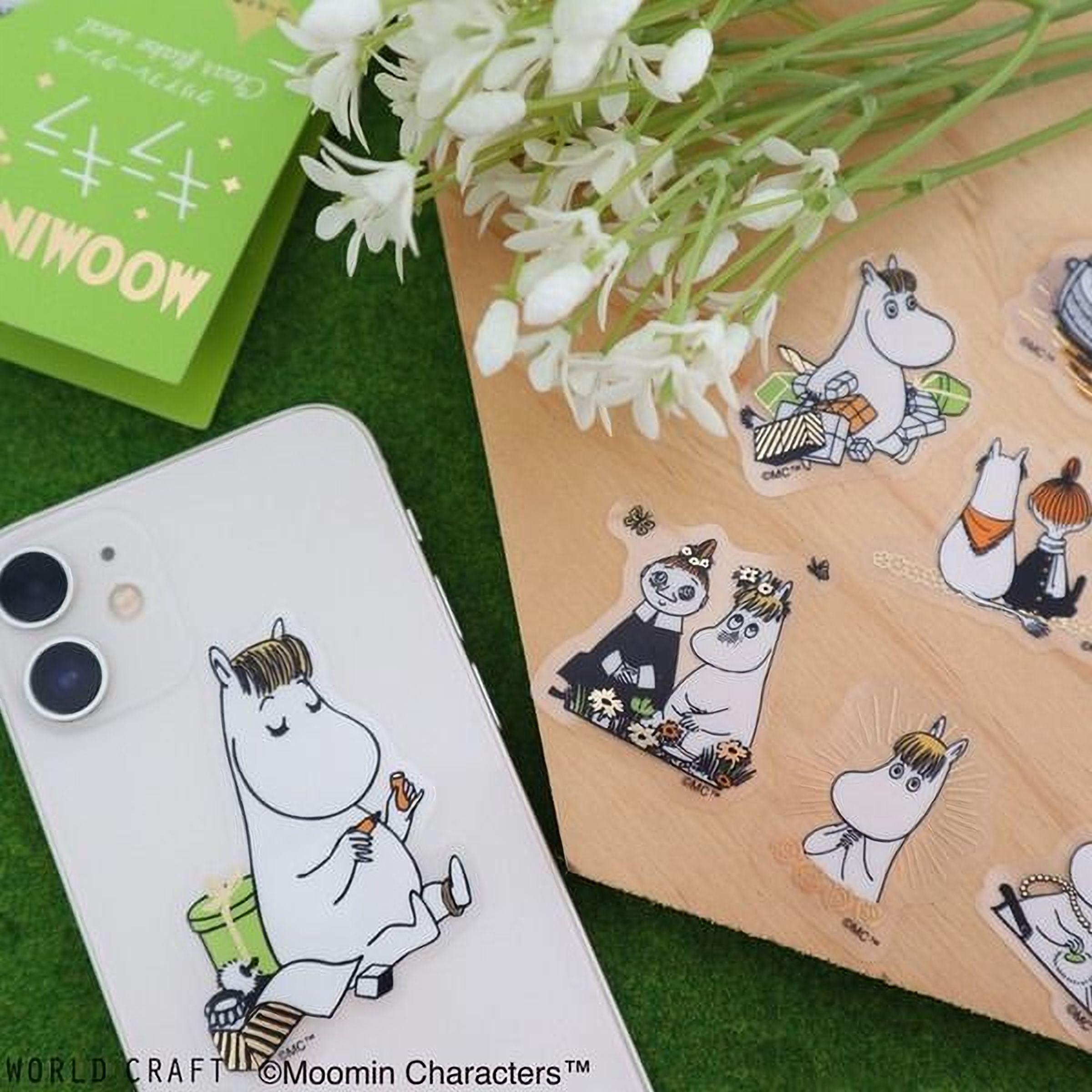 a collection of stickers and a phone case with Moomin character illustrations, including a character holding a gift and another character with a hat.