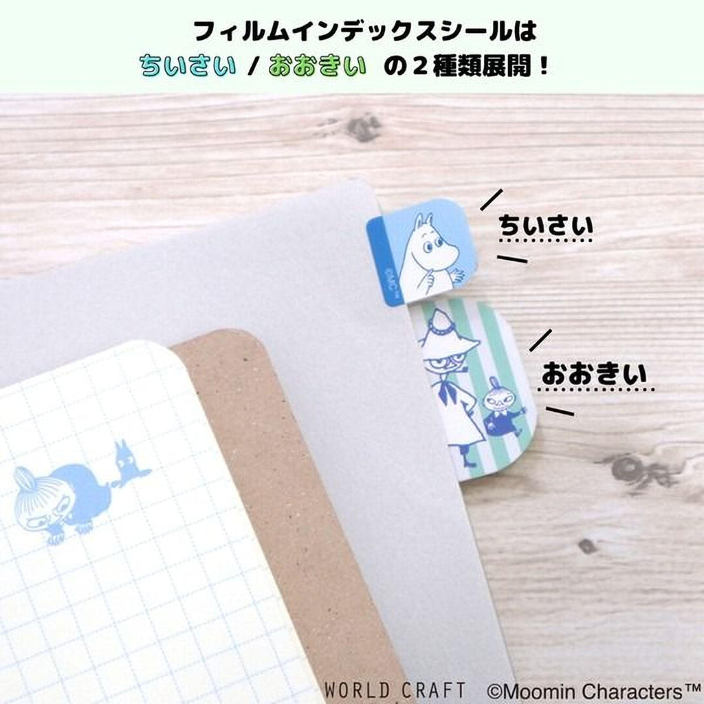 A collection of various items, including a notebook, a pen, and a small object with a cartoon character, arranged on a wooden surface.
