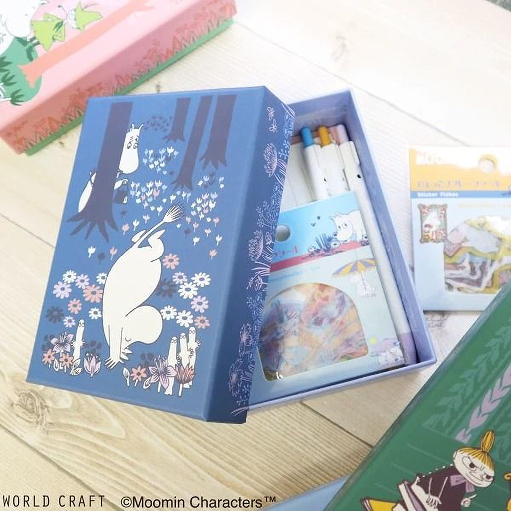 a blue box with a cartoon illustration of a white bear and various flowers, along with a set of pens and a small picture book.