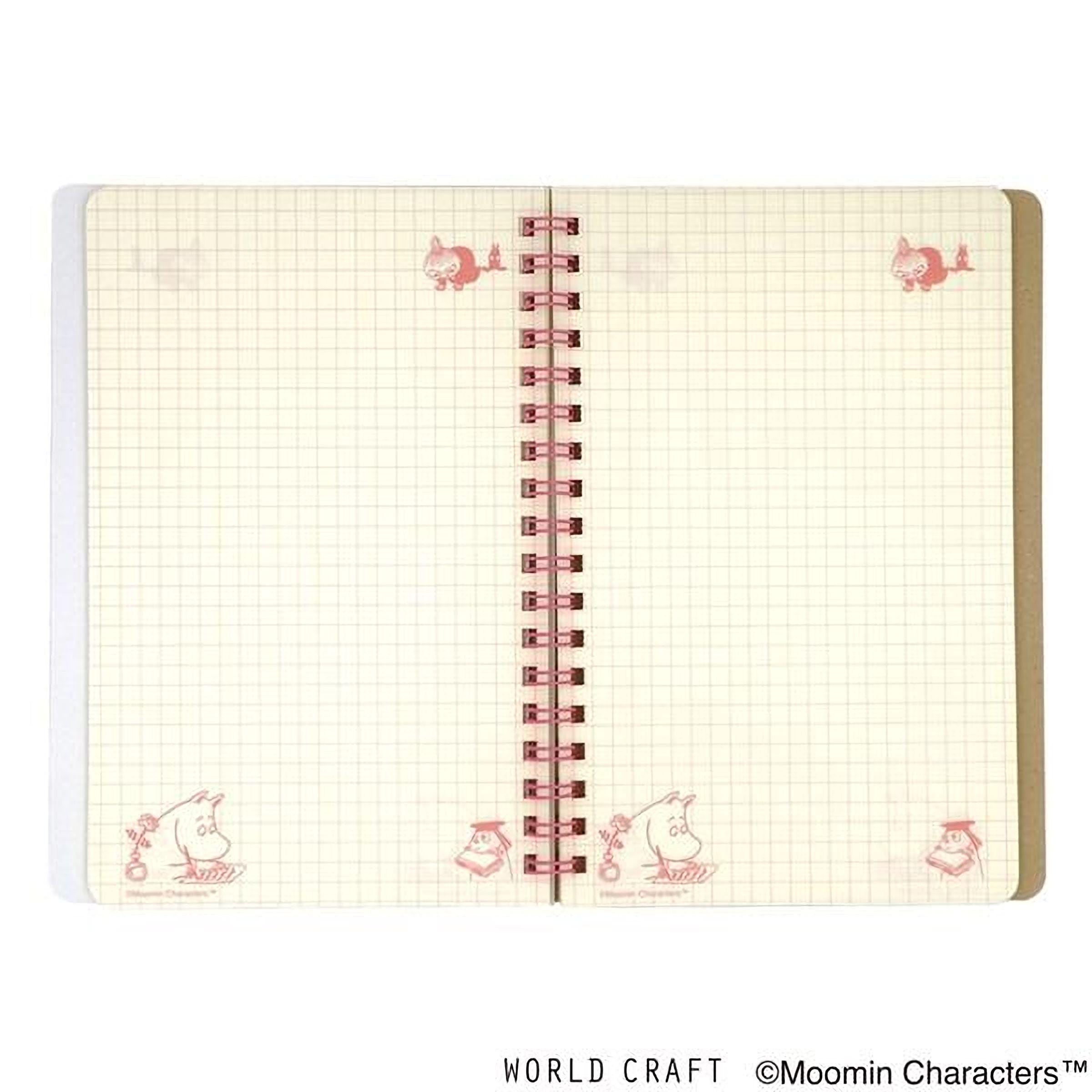 an open spiral-bound notebook with a grid pattern on the pages.