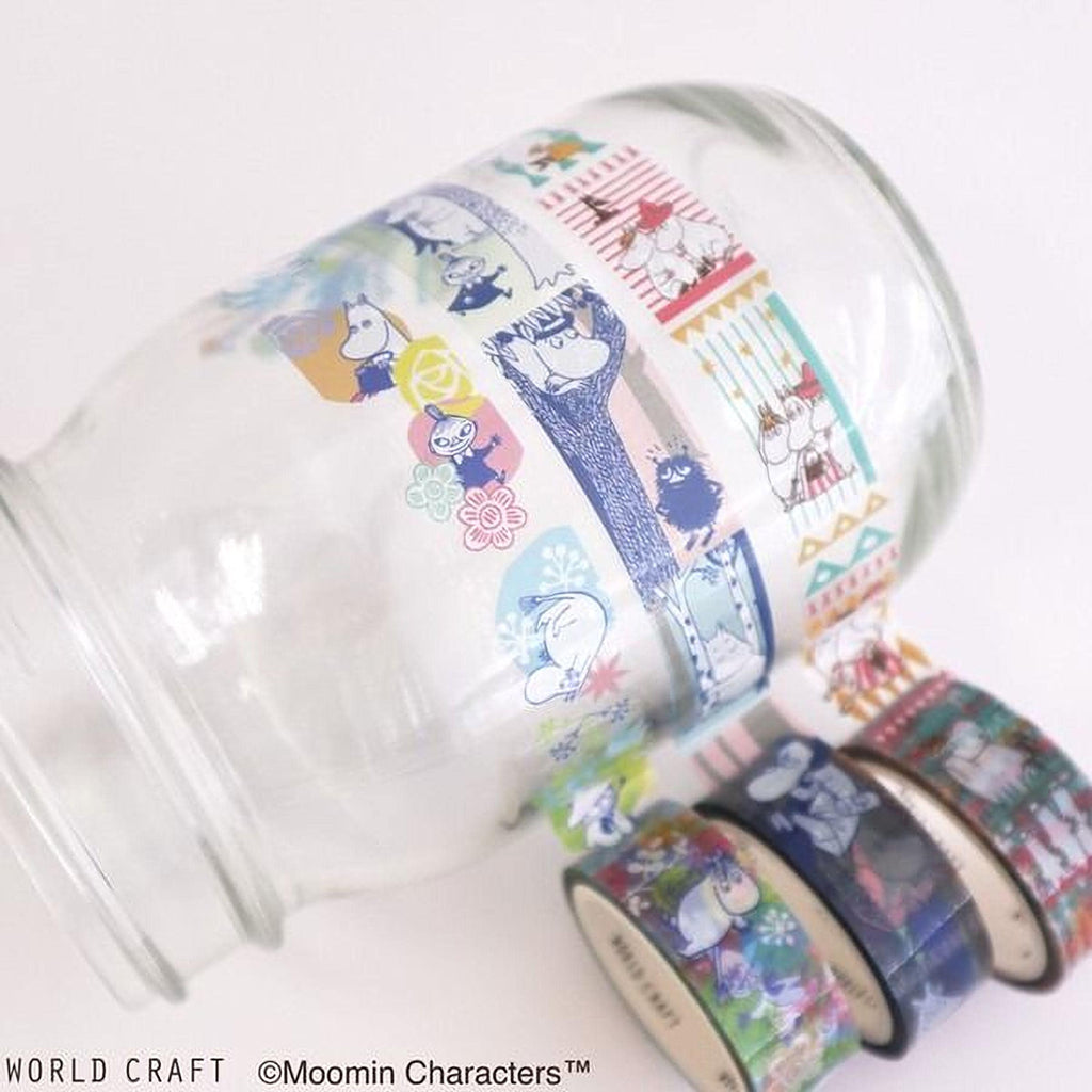 A glass jar with colorful, patterned tape around it, featuring various cartoon characters and designs.