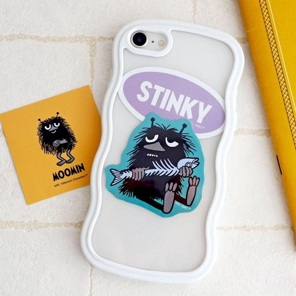 a phone case with a cartoon character sticker on it, along with a yellow sticker and a yellow object in the background.