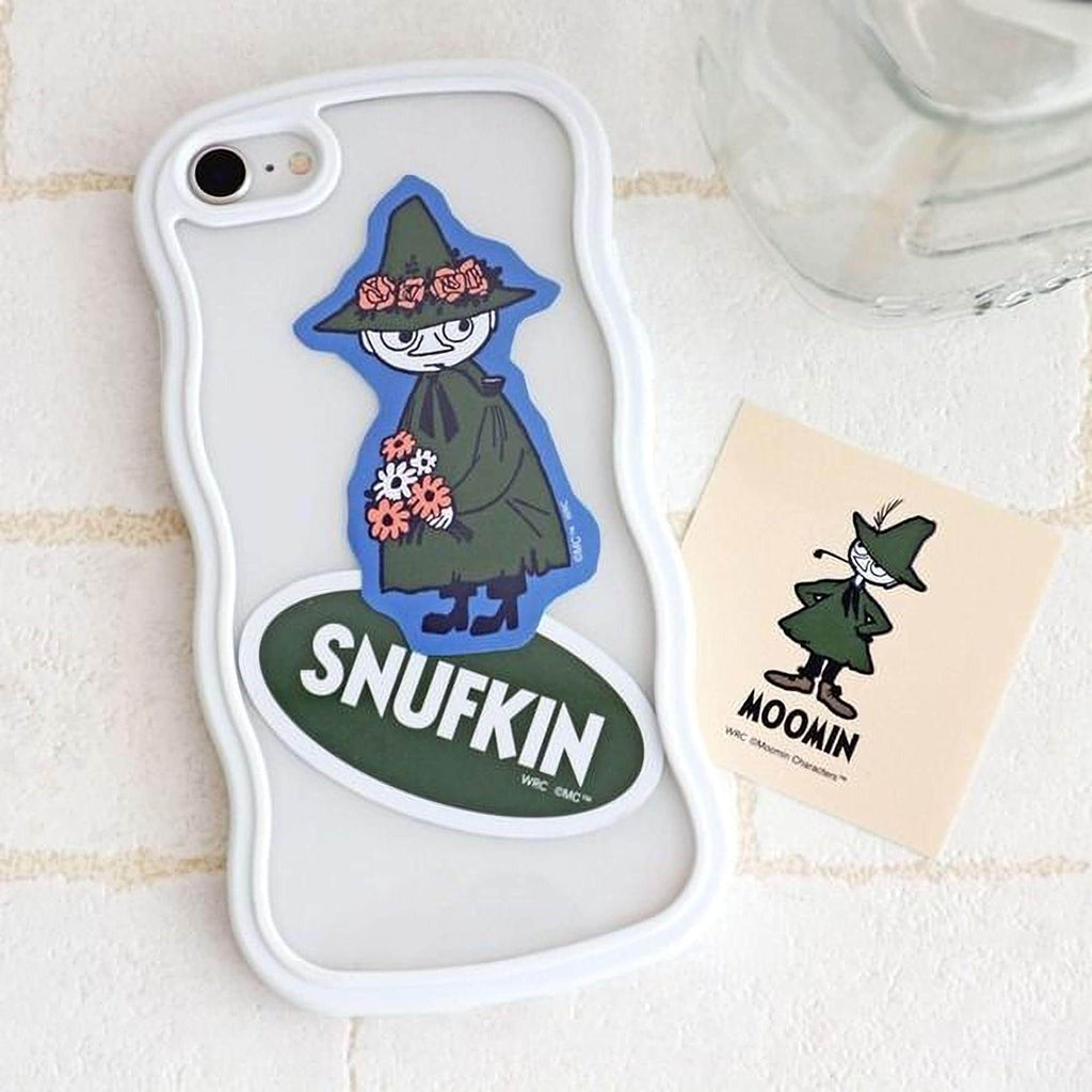 a white phone case with a sticker of Snufkin, a character from the Moomin cartoon series, and a small sticker of Moomin characters.