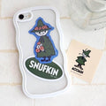 a white phone case with a sticker of Snufkin, a character from the Moomin cartoon series, and a small sticker of Moomin characters.
