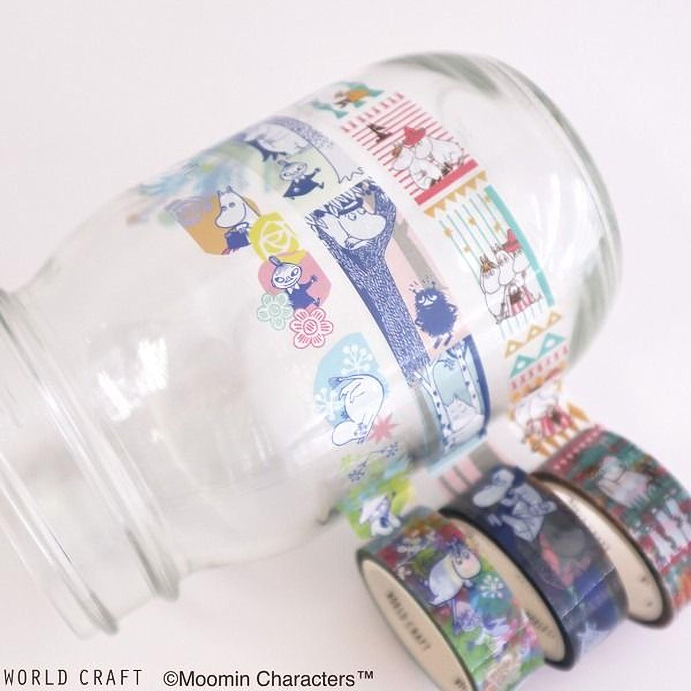 A glass jar with colorful, patterned tape around it, featuring various cartoon characters and designs.