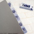 A gray folder with a row of purple stickers featuring cartoon-like creatures sticking out from the top edge.