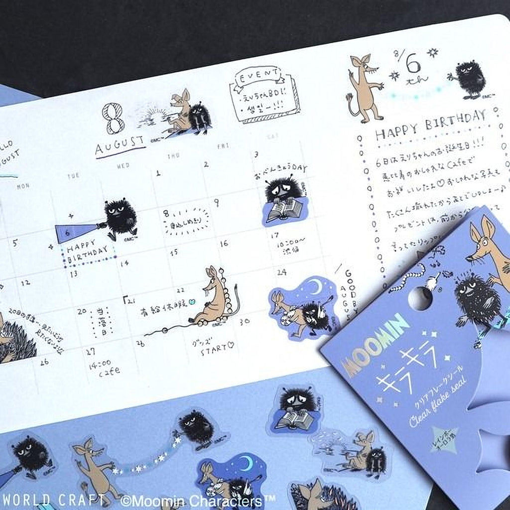 a calendar with various stickers and illustrations, including a kangaroo, hedgehog, and other animals, along with Japanese text. The calendar appears to be a creative and personalized item, possibly used for planning and organizing events or activities.