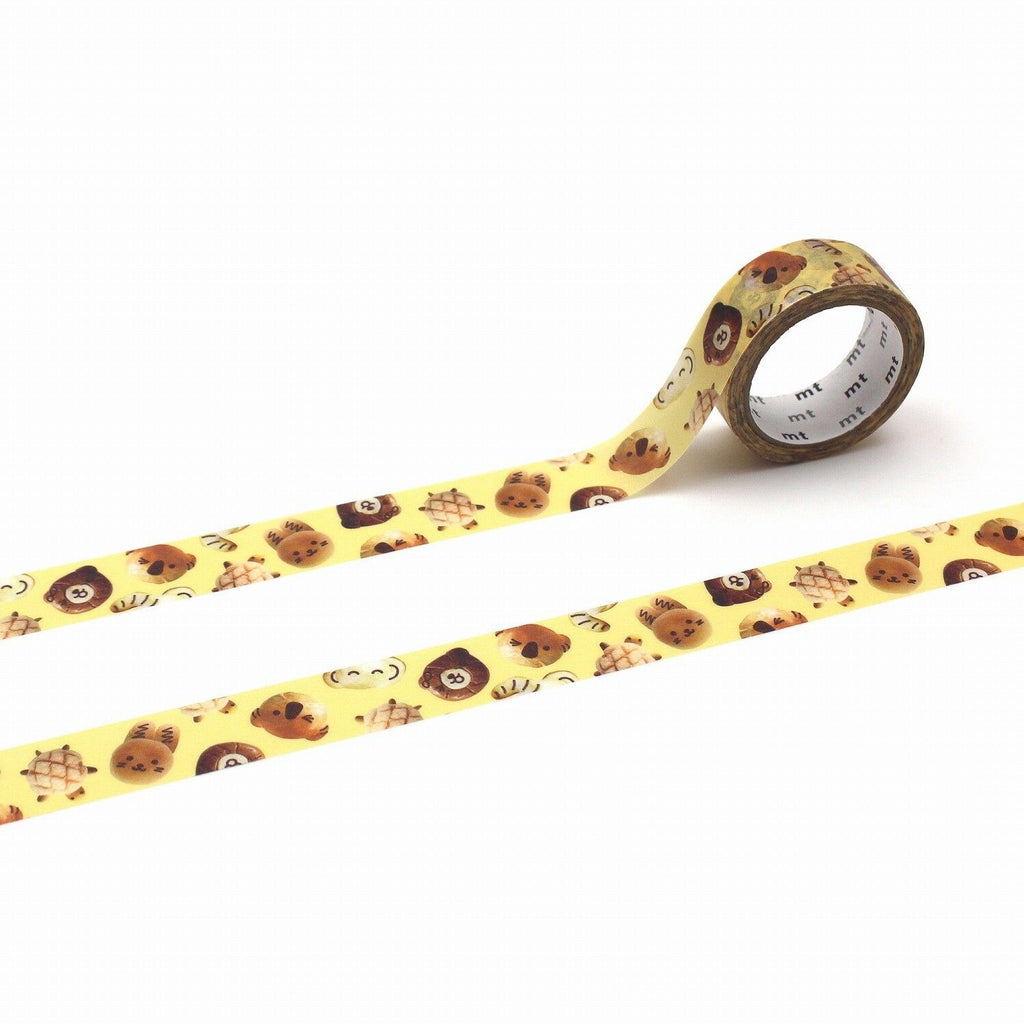 a roll of yellow tape with a pattern of brown animal faces, including a lion, tiger, and bear, printed on it.