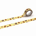 a roll of yellow tape with a pattern of brown animal faces, including a lion, tiger, and bear, printed on it.