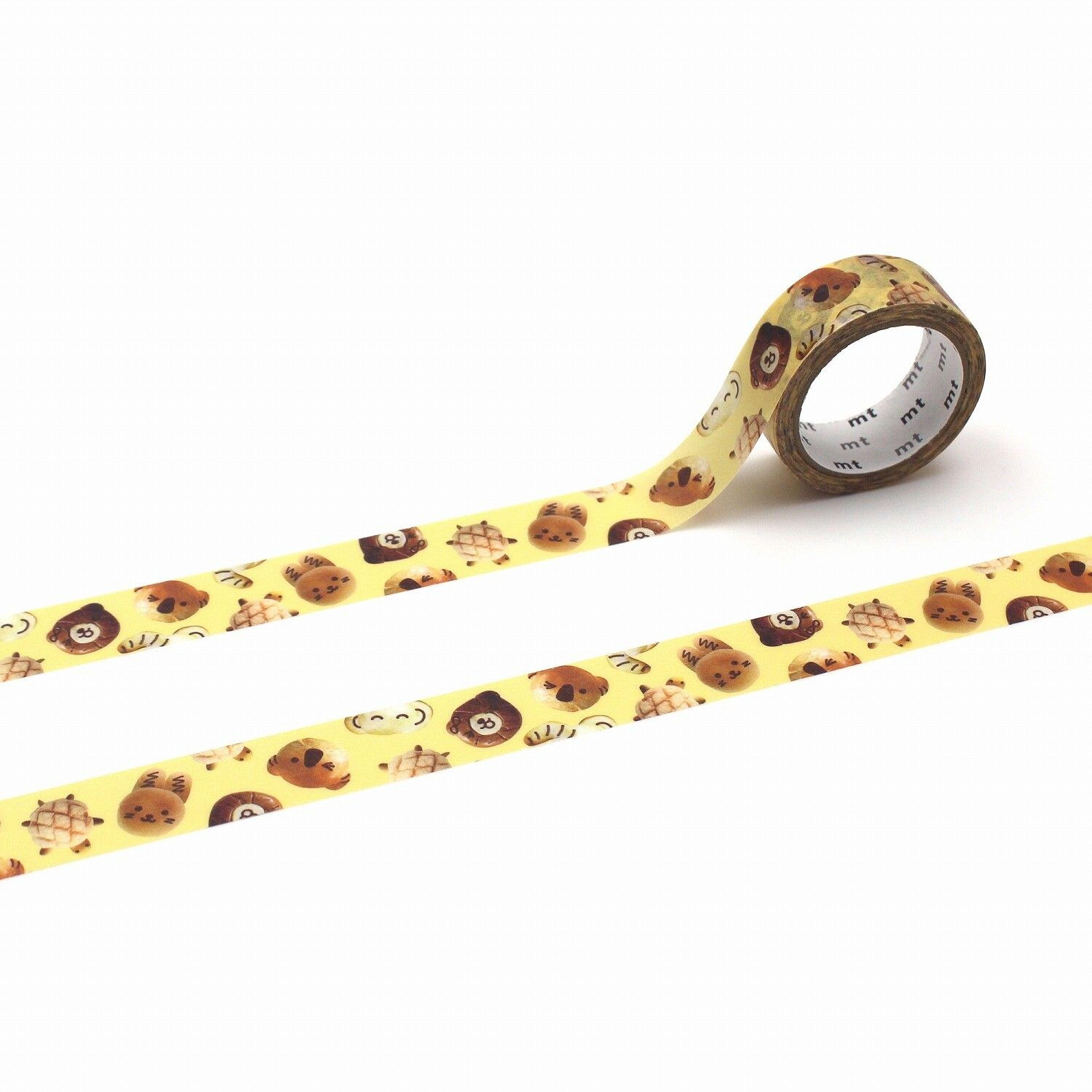 a roll of yellow tape with a pattern of brown animal faces, including a lion, tiger, and bear, printed on it.
