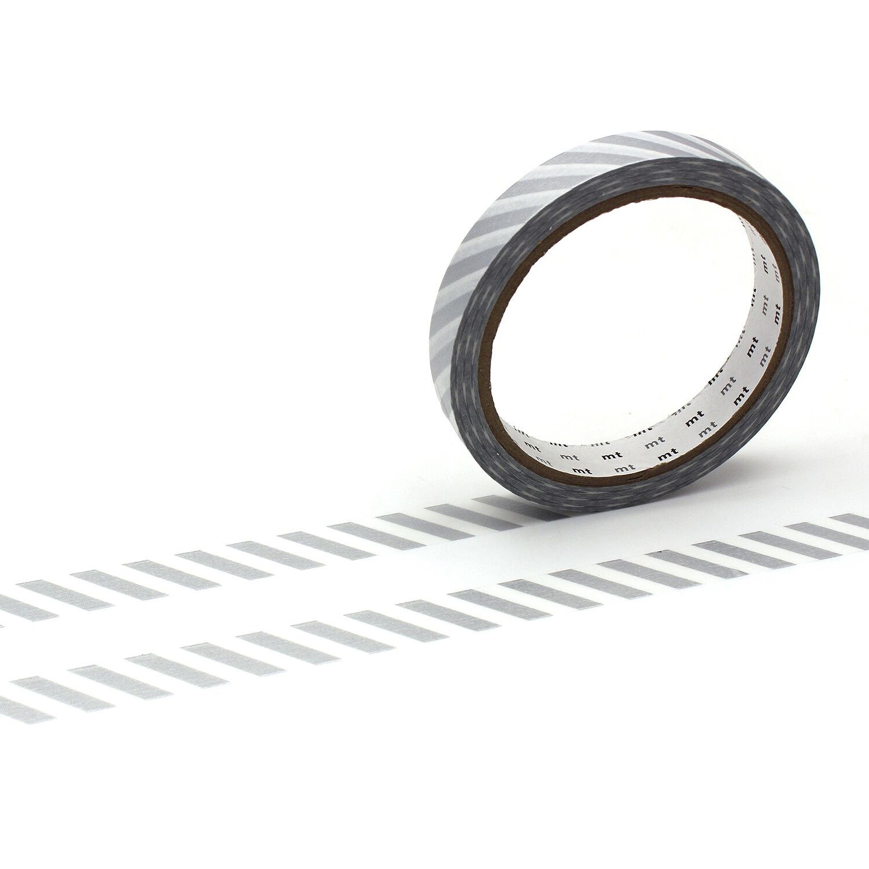 A roll of black and white striped tape is lying on a white surface, with a shadow cast by the tape.