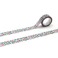 a roll of patterned tape with a floral design, lying on a white surface.